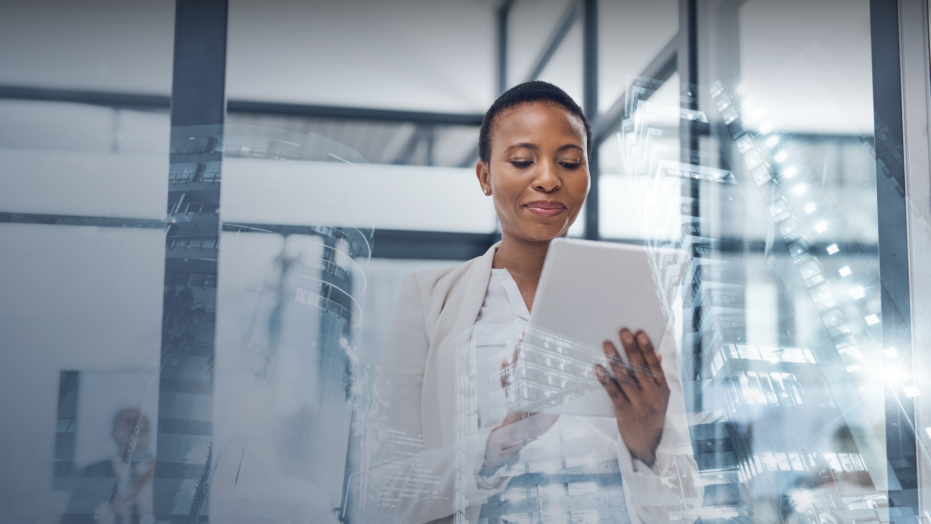 Business woman smiling and looking down at held tablet