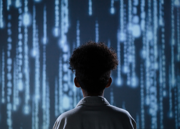 back view of a person looking at a light up screen