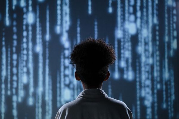 back view of a person looking at a light up screen