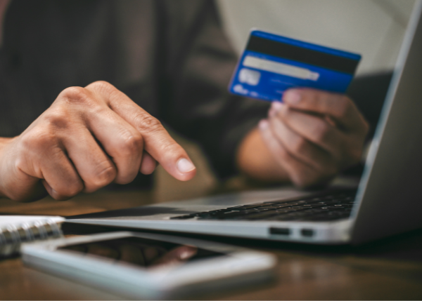 A person paying for something online with a laptop.