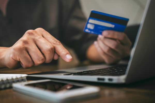 A person paying for something online with a laptop.