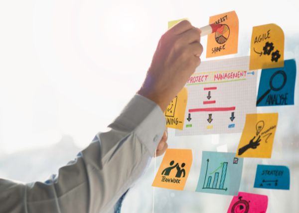 Person writing on a sticky note