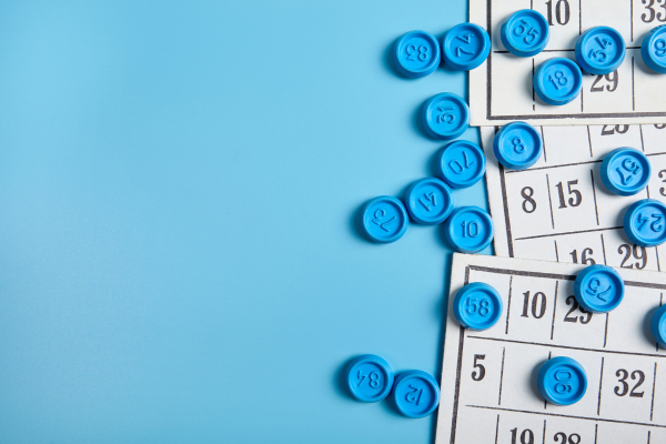 Bingo card and pieces with a light blue background