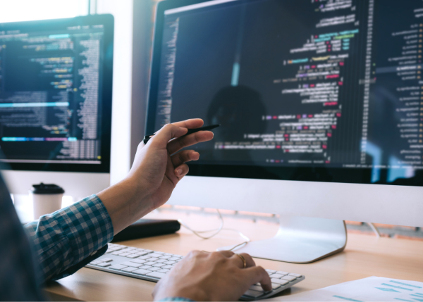 Person looking at HTML on a monitor.