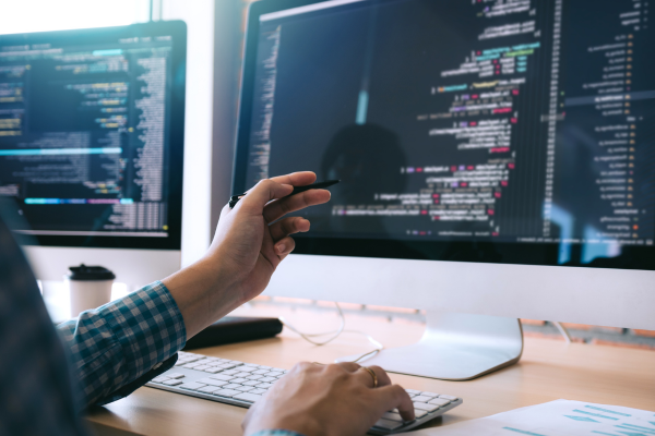 Person looking at HTML on a monitor.