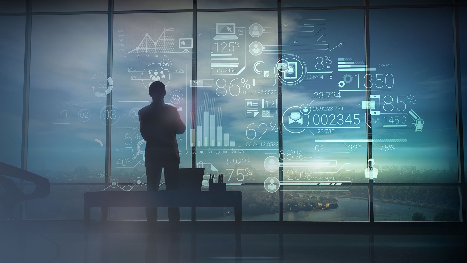 Person looking at glass wall illuminated by tech graphics