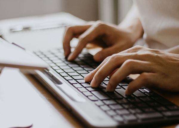 Person typing on a keyboard