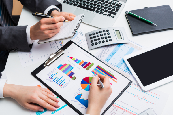 People looking at graphs and charts, analyzing data.