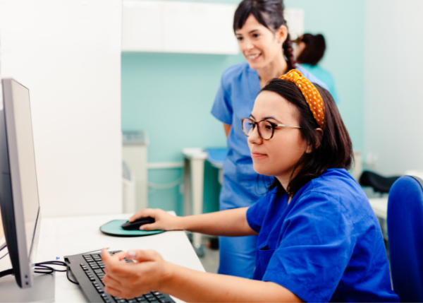 Hospital workers looking at a computer