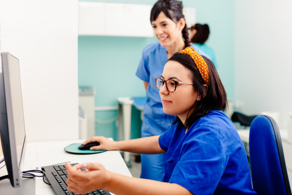 Hospital workers looking at a computer