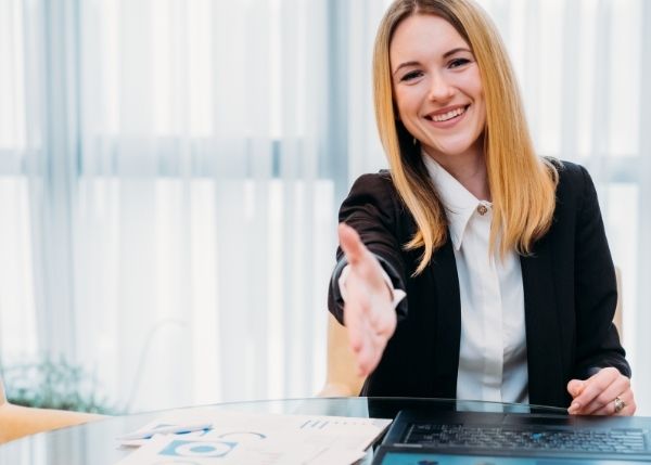 Businesswoman with her hand outstretched for a handshake