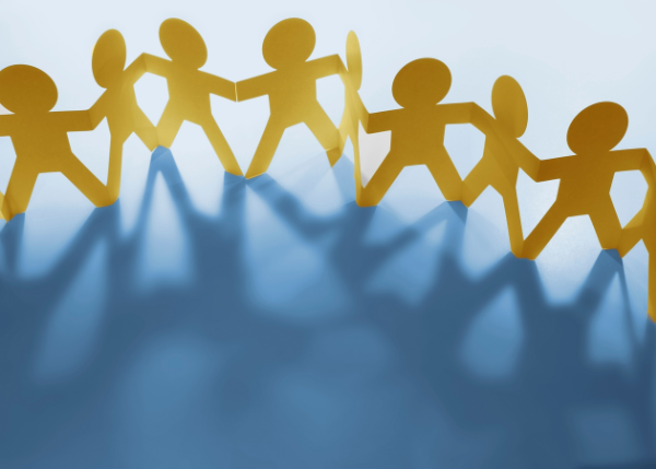 Paper cutout of people holding hands