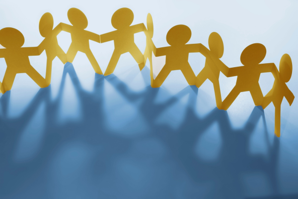 Paper cutout of people holding hands