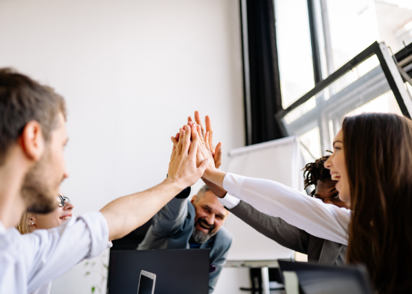 People working together and giving a high five