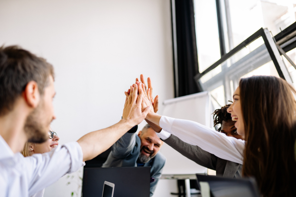 People working together and giving a high five